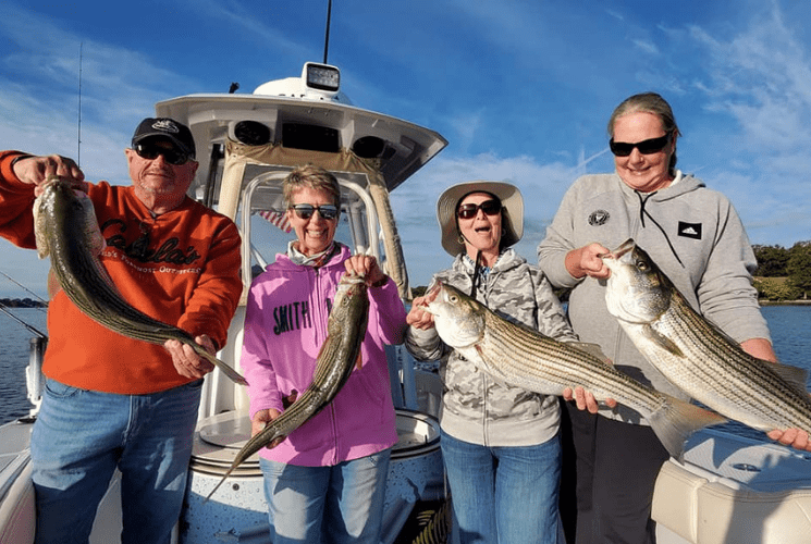 photo of 4 guests on a striper fishing guide trip