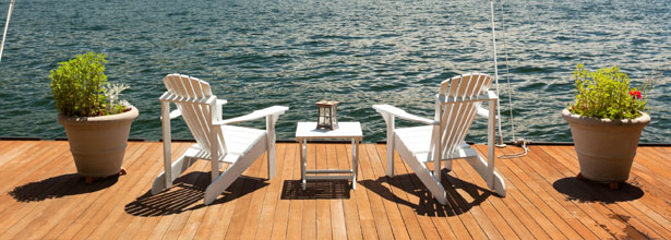 adirondack chairs on a lake deck