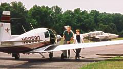 Warren Theis and Lisa Raub, refueling Warren's 1966 Mooney at Smith Mountain Lake Airport. Photo Copyright 1999 by Brian Raub