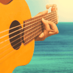 Acoustic guitar with lake in background