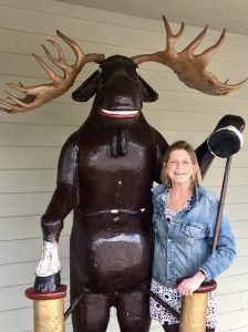 Deb Beran of Smith Mountain Lake poses for a photo with the giant fiberglass moose outside of Moosie's restaurant