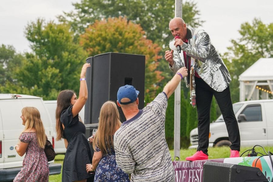 A member of the band Spanx interacts with the crowd at the SML Wine Festival at Bernard's Landing.