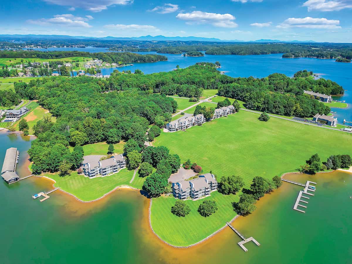 An aerial view of condos, green space, lake and mountains at Bernard's Landing at Smith Mountain Lake, VA.