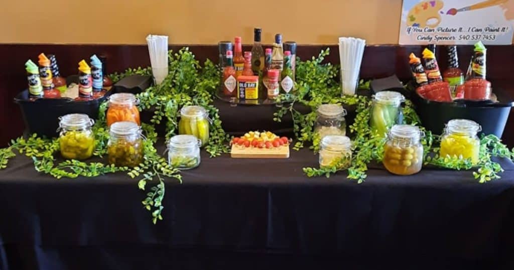 A table filled with colorful accompaniments for Bloody Marys.