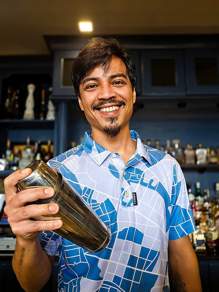 Bartender in festive shirt mixing a cocktail at Tiff's Lakefront restaurant at Smith Mountain Lake, VA.