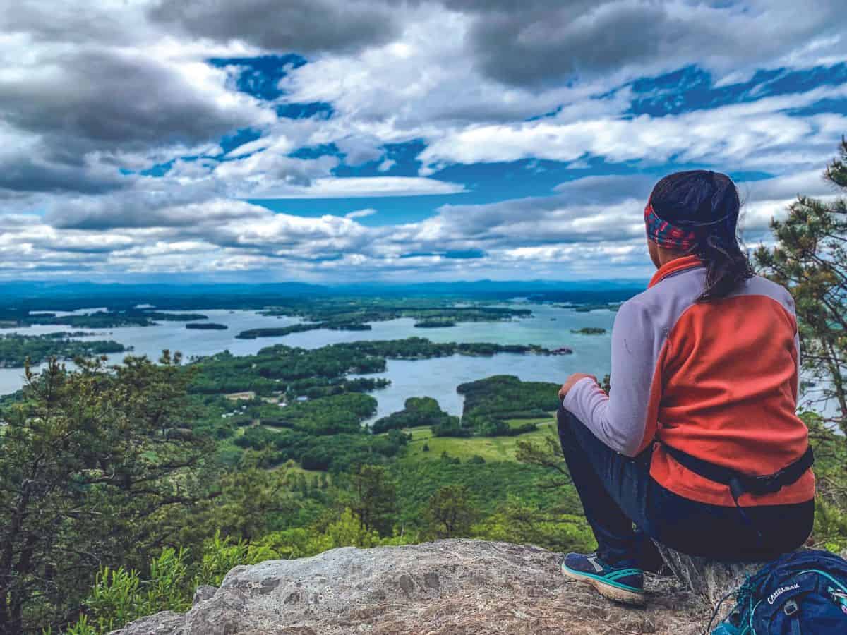 A hiker takes in the view of Smith Mountain Lake from the top of Smith Mountain.