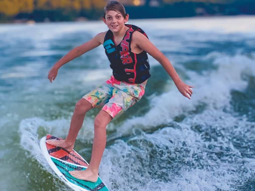 A young wake surfer rides at Smith Mountain Lake