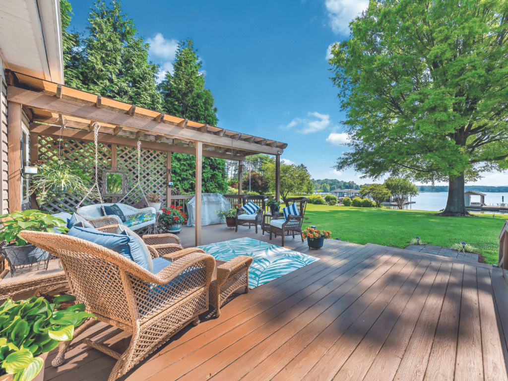 Relaxing outdoor deck with blue lake and trees in background at Smith Mountain Lake, Virginia.