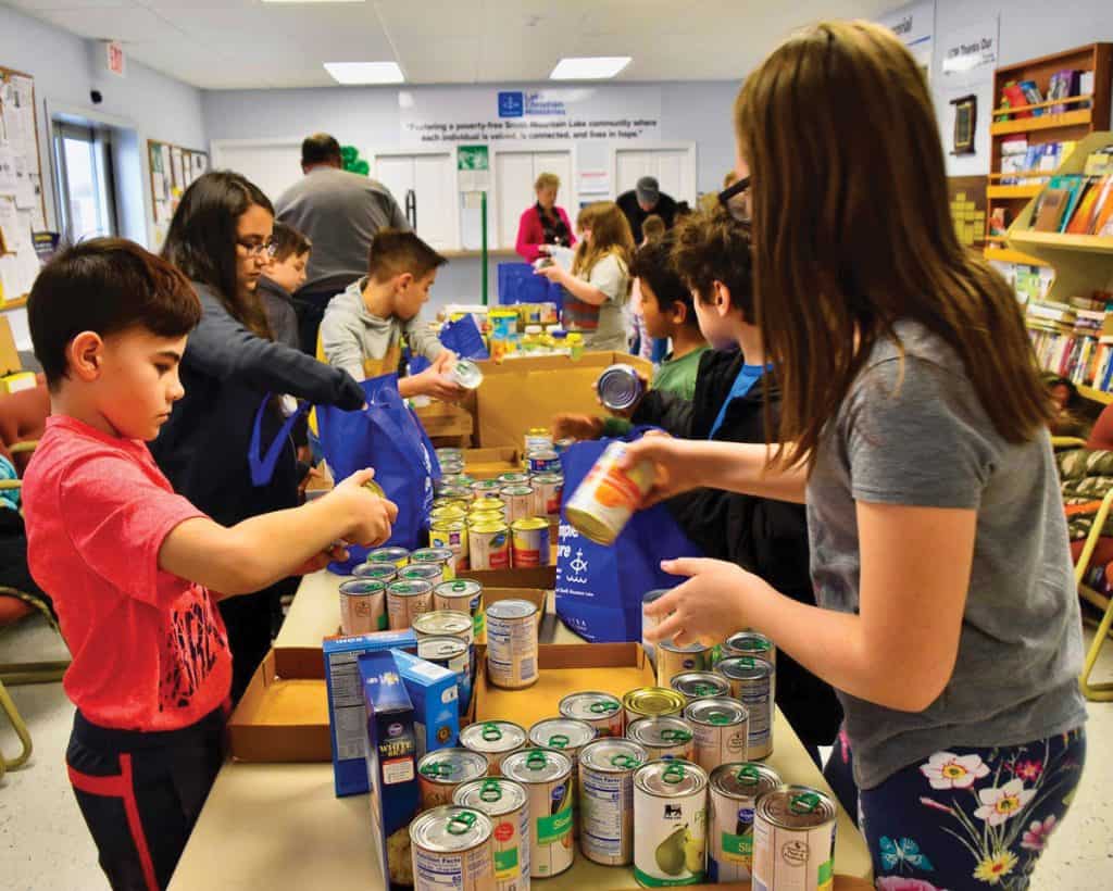 Volunteers sort food at Lake Christian Ministries