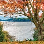 Two fishermen on Smith Mountain Lake with colorful fall foliage.