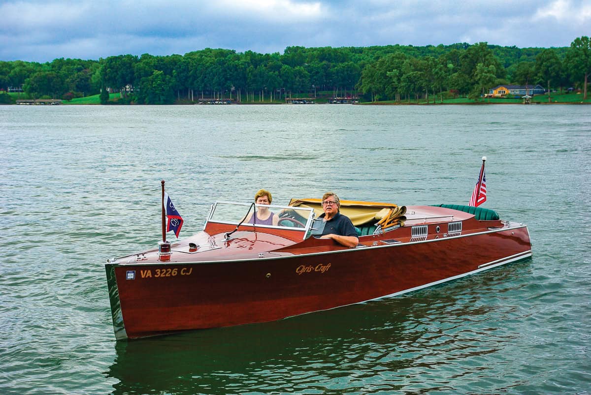 Jennifer and Mark Thompson aboard their restored 1929 Chris Craft on Smith Mountain Lake.