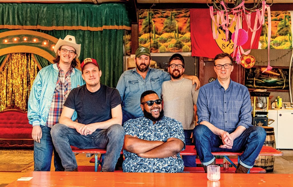 Members of the band Town Mountain with colorful background.