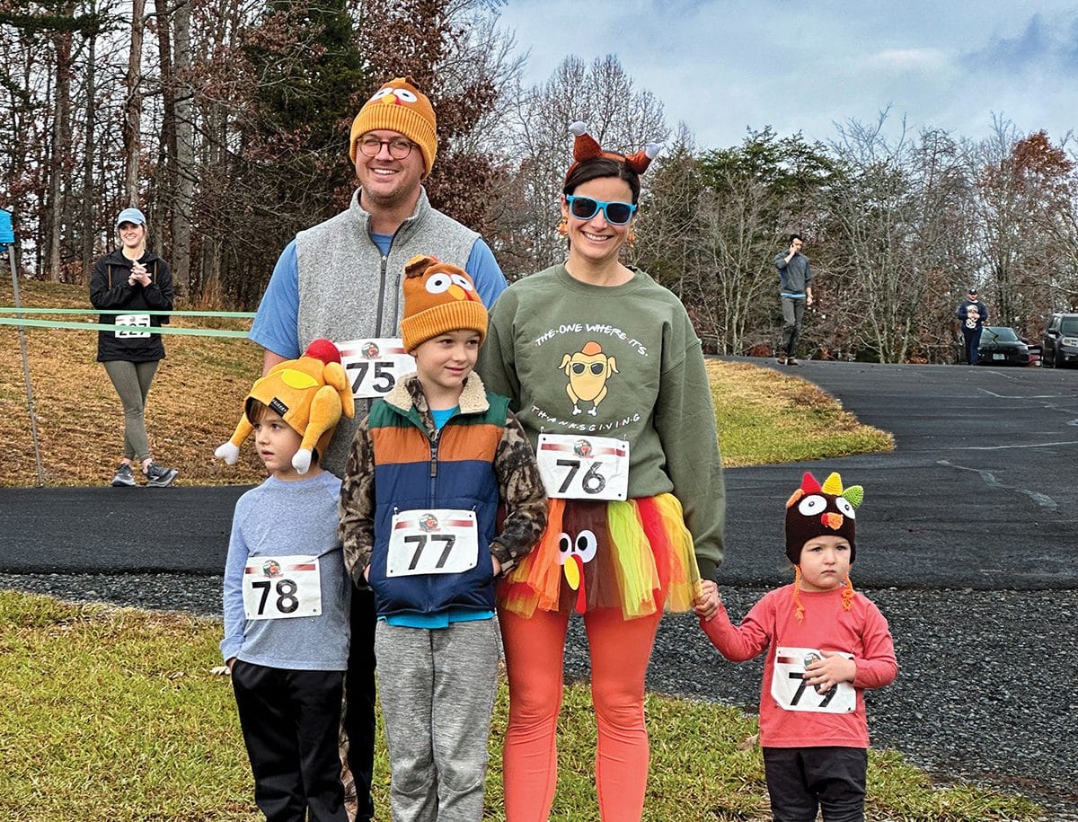 A family of runners dressed in fall colors starting the Turkey Trot at Smith Mountain Lake State Park.