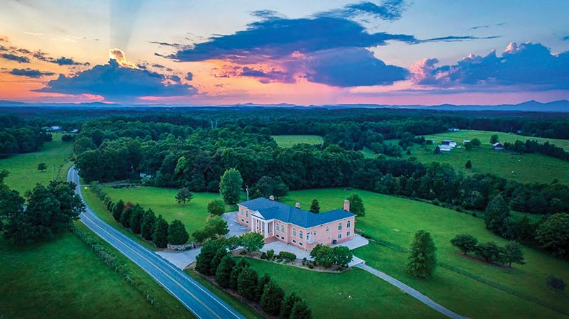 Sunset over Smith Mountain Manor, a brick mansion at Smith Mountain Lake that hosts special events, including weddings.