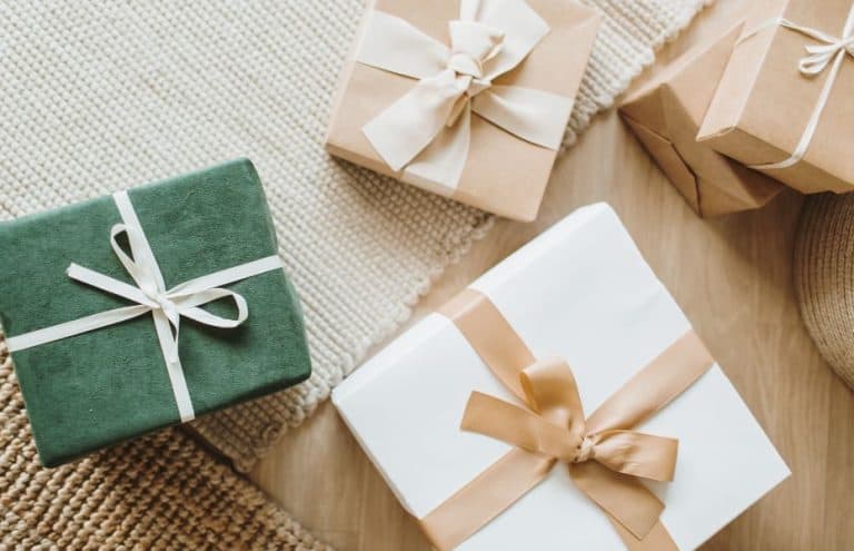 Beautifully wrapped gifts in brown, green and cream paper and ribbons.