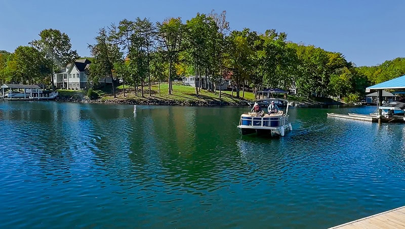 A pontoon pulls up to a floating dock at Smith Mountain Lake, Virginia.