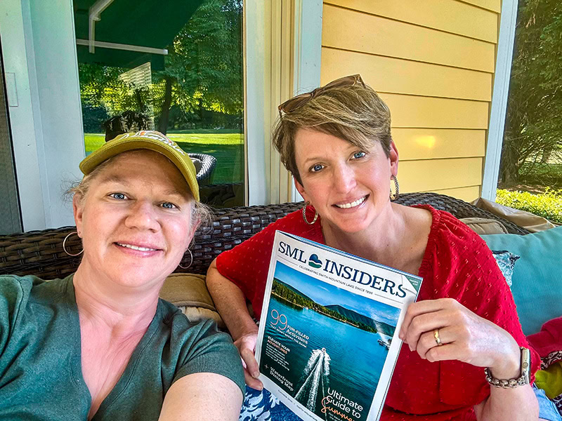 Jennifer Church and Andie Gibson, SML Insiders publishers, holding the inaugural issue of the magazine.
