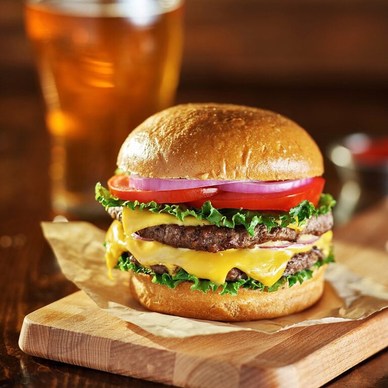 Juicy double cheeseburger and cold draft beer.