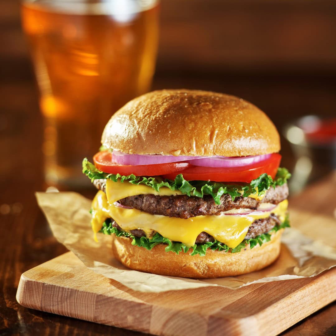 Juicy double cheeseburger and cold draft beer.