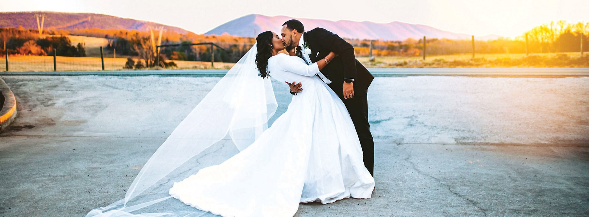 groom and bride kissing with Smith Mountain Lake in the background