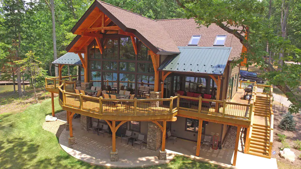 Timber frame home on Smith Mountain Lake with soaring windows and wrap-around deck.