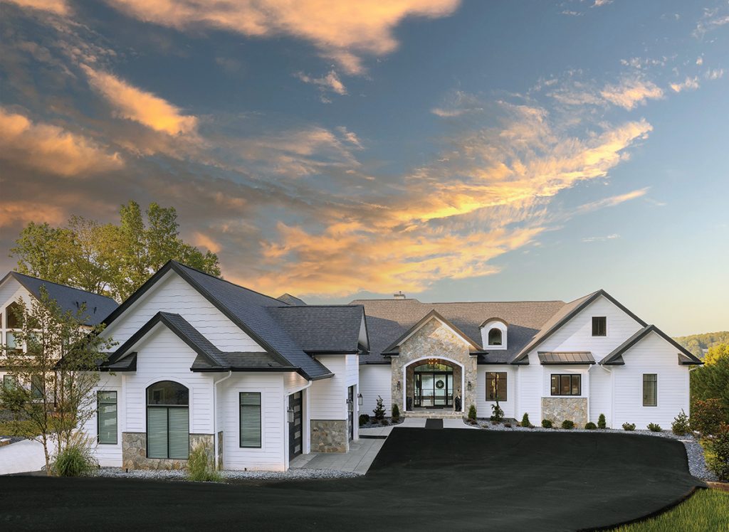 Modern farmhouse lakefront home exterior at Smith Mountain Lake during the charity home tour at sunset.