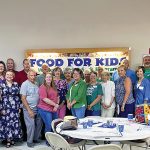 Volunteers with Food for Kids prepare to fill bags of food for students in Bedford County, Virginia, near Smith Mountain Lake