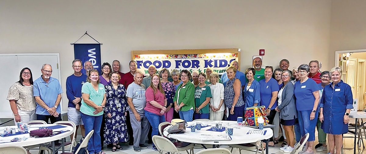 Volunteers with Food for Kids prepare to fill bags of food for students in Bedford County, Virginia, near Smith Mountain Lake