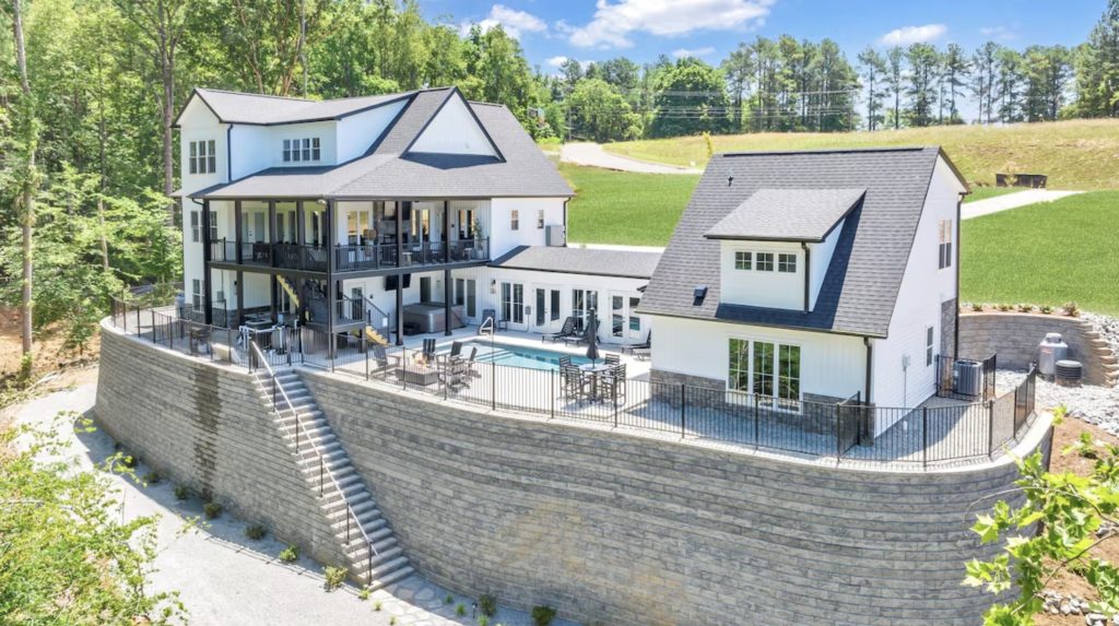 Huge white farmhouse vacation rental at Smith Mountain Lake with pool, deck and lake access.