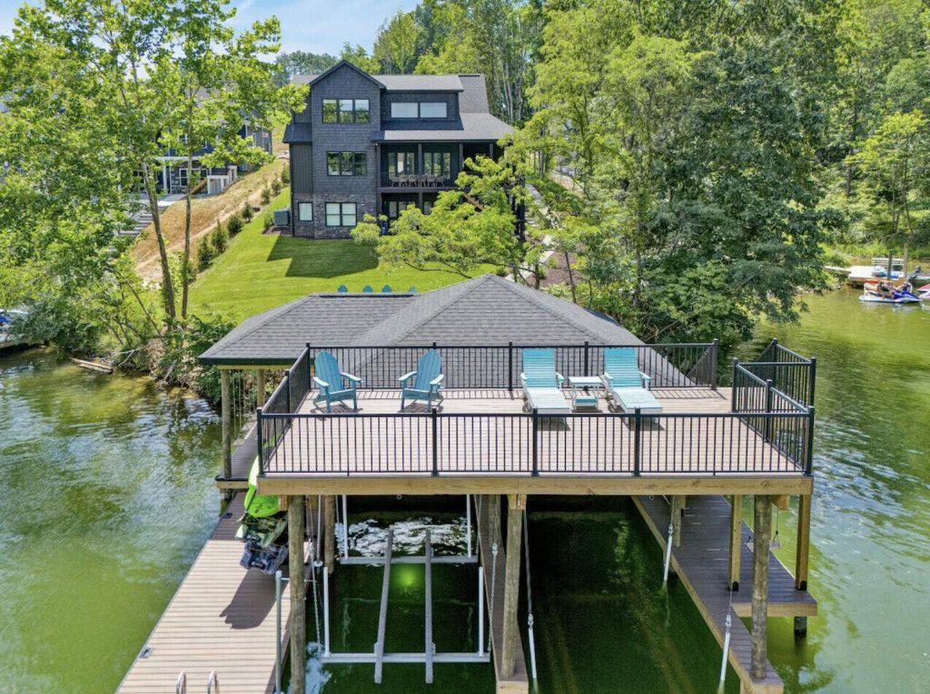 Aerial view of lakefront home with large dock and sundeck for group vacations at Smith Mountain Lake, Virginia.