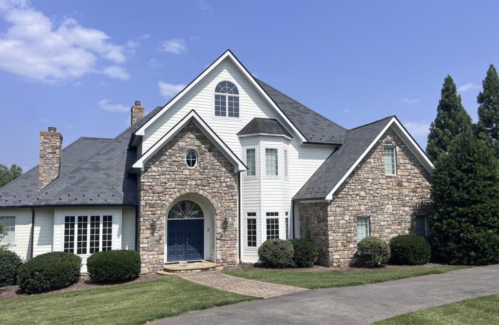 Expansive rental home on Smith Mountain Lake with stone facade.