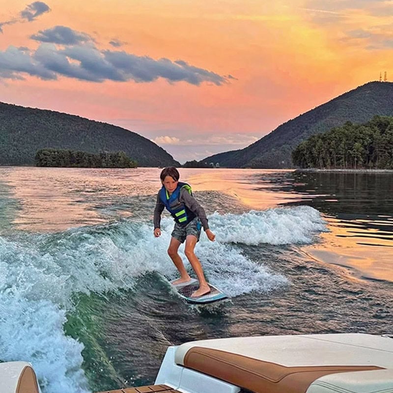 Relaxing outdoor deck with blue lake and trees in background at Smith Mountain Lake, Virginia.
