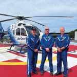 Carilion Life-Guard air ambulance flight crew members in blue flight suits standing together at helipad
