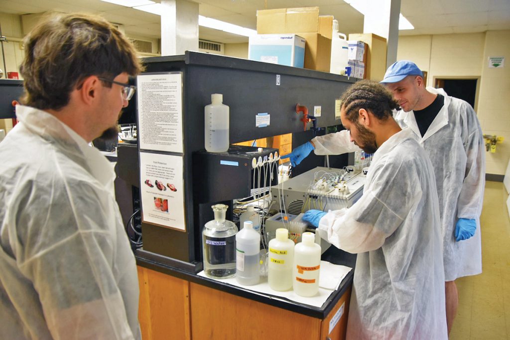 Ferrum College student technicians analyzing total phosphorus water samples in laboratory.