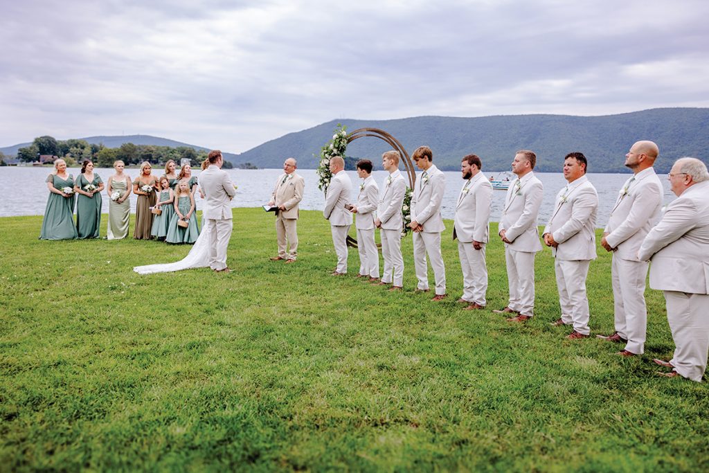 Wedding party standing on lawn at Parkway Marina with Smith Mountain Lake behind them