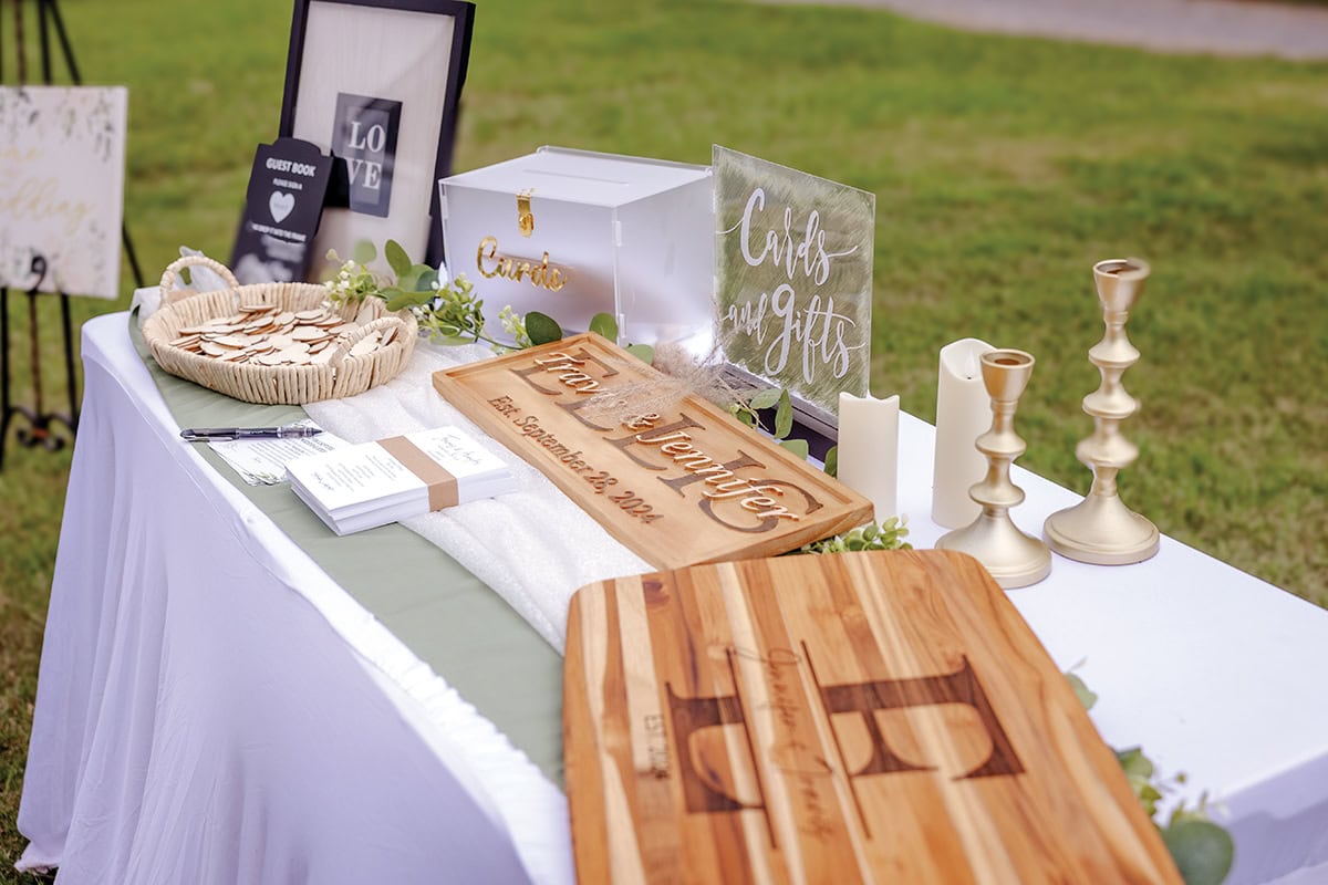 Elegant guest table with sage green linens and wedding gifts at Parkway Marina Smith Mountain Lake