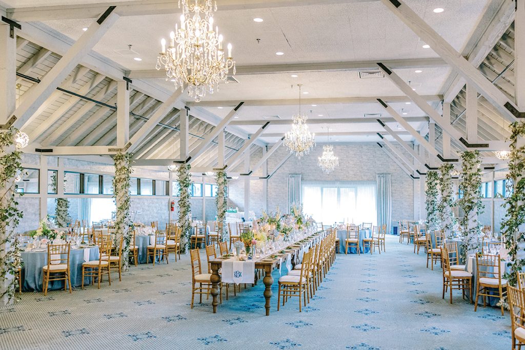 A wedding reception hall decorated in white and blue at The Water’s Edge Country Club at Smith Mountain Lake, photographed by Megan Lampert Photography.