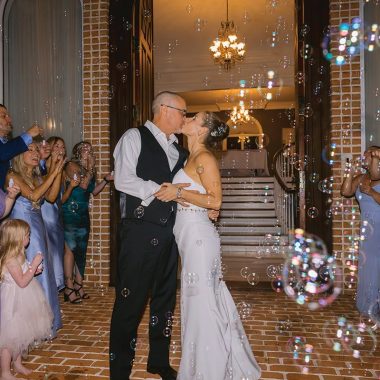 A bride and groom walk out for a bubble send off at Smith Mountain Manor wedding venue, photographed by Amative Creative