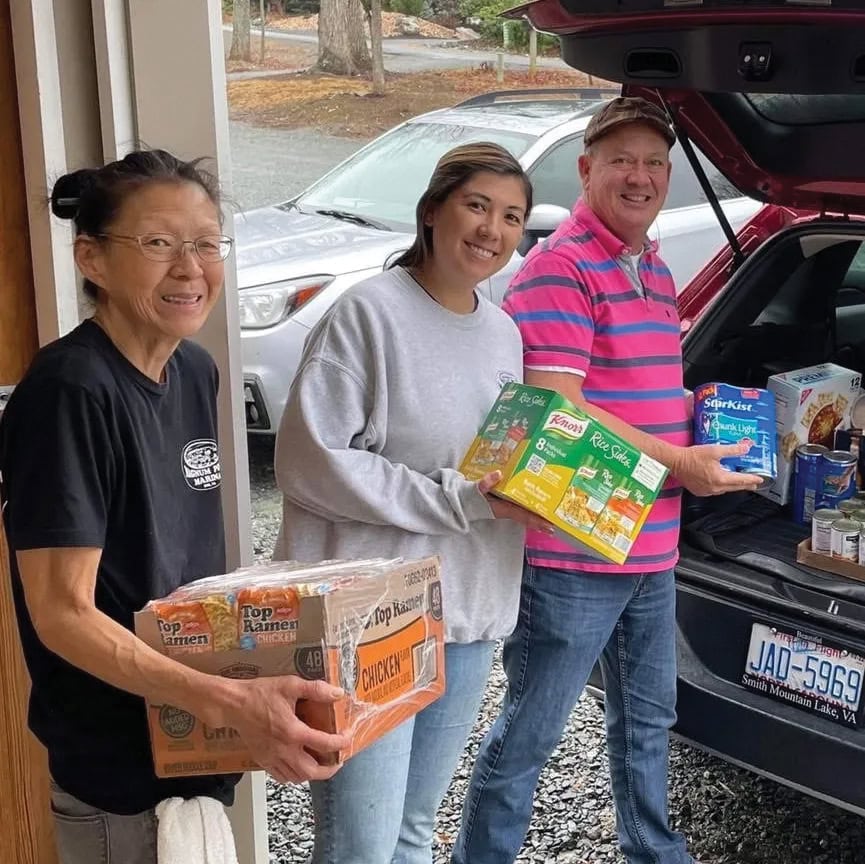 Volunteers load donations of food into a vehicle for SML Gives Inc at Smith Mountain Lake