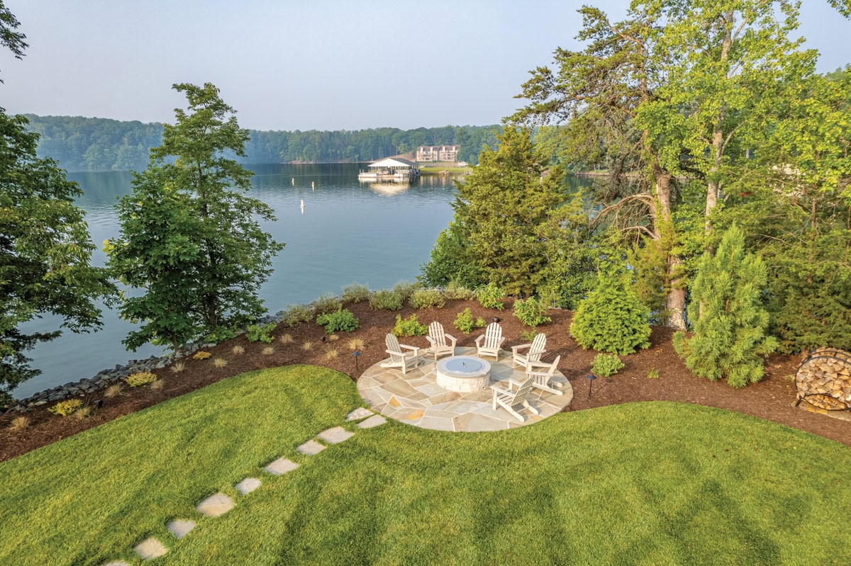 Firepit gathering area nestled into natural stone and greenery at Smith Mountain Lake.