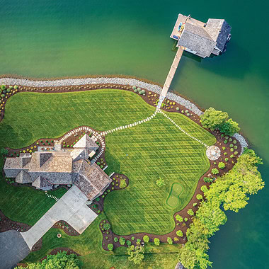 Aerial view of a landscaped lakefront property with multiple outdoor destinations at Smith Mountain Lake.