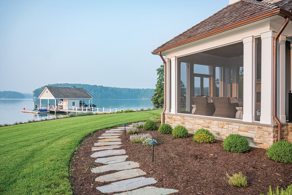 Natural stepping-stone pathway connecting a porch to the landscape at a Smith Mountain Lake home.