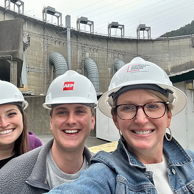 Andie Gibson, Casey Johnson and George Cooper wearing safety helmets during a tour at Smith Mountain Dam.