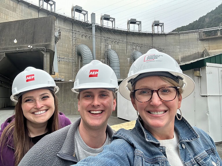Andie Gibson, Casey Johnson and George Cooper wearing safety helmets during a tour at Smith Mountain Dam.