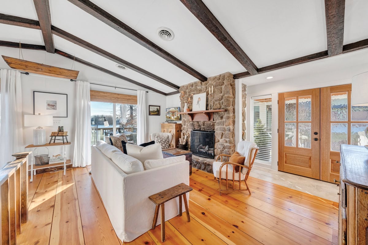 Wide pine floors preserved in a waterfront cottage remodel near Virginia Dare Marina.