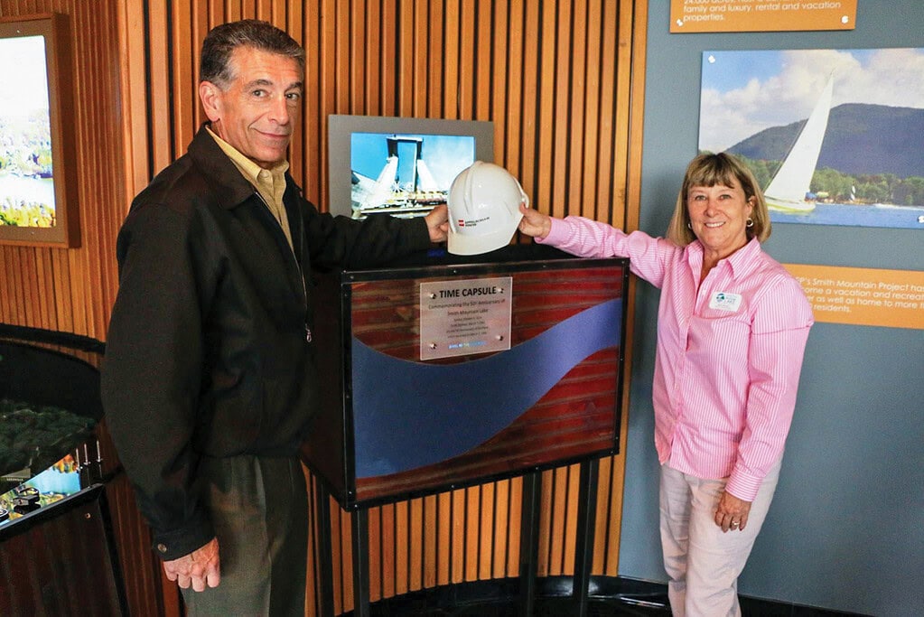 Larry Jackson and Barb Nocera pose in front of the time capsule containing mementos from the 5oth anniversary celebration at the Vipperman Visitor Center.