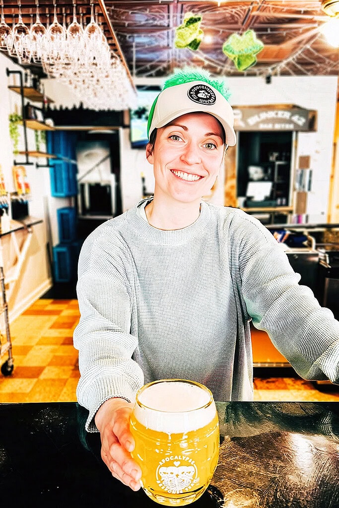 Young woman serves a draft beer at a craft brewery near Smith Mountain Lake, VA.
