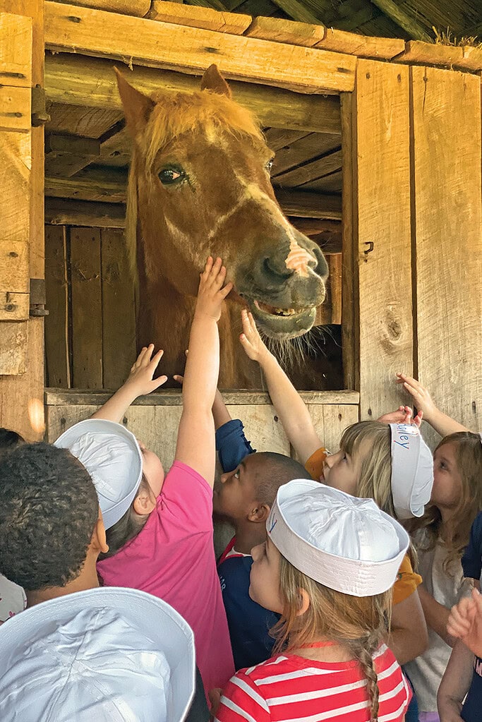 Children pet a horse at Booker T. Washington National Monument in Franklin County, Virginia.