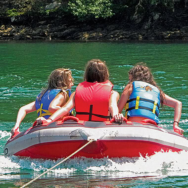 Three kids on an inflatable at Smith Mountain Lake, Virginia.