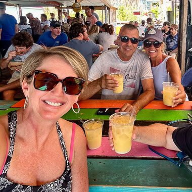 Two couples with tropical drinks at Portside, a popular bar at Smith Mountain Lake, VA.